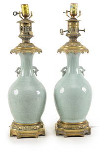 Pair of antique Chinese carved celadon porcelain vases with bronze mounts converting them to oil: Pair of antique Chinese carved celadon porcelain vases with bronze mounts converting them to oil lamps and later to electrified lamps. Fine quality bronze mounts. Overall height 23.5in. Vase height ap