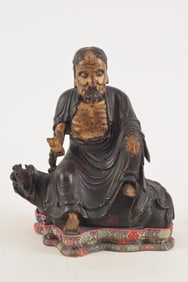 Chinese 18th century or earlier carved hardwood buddha figure seated on a dragon. Gilt decoration.
