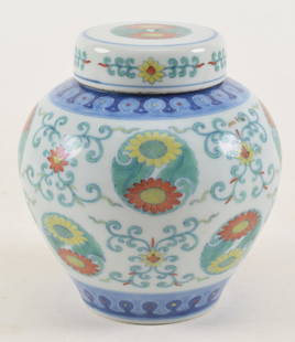 Porcelain covered jar. China. Chien lung mark and period (1735-1796). Tou tsai ware. With overall: Porcelain covered jar. China. Chien lung mark and period (1735-1796). Tou tsai ware. With overall floral pattern. Height 5 in.