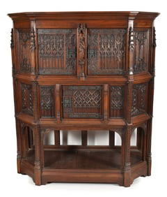 Early 20th century Gothic revival walnut cabinet with carved and architectural panels and a figure