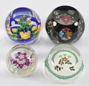 4 Perthshire art glass paperweights with floral designs and facets. Some with original labels.