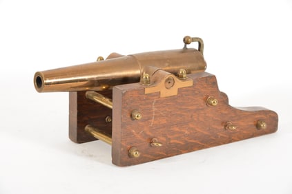 19th/20th century brass yacht signal cannon. Flat oak carriage with brass mounts. Appears unmarked.