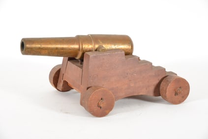 19th/20th century brass signal cannon with wooden carriage and wheels. Appears unsigned. Tarnishing