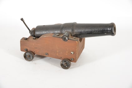 Early 20th century cast iron signal cannon. Wooden carriage with cast iron wheels and mounts. Screw