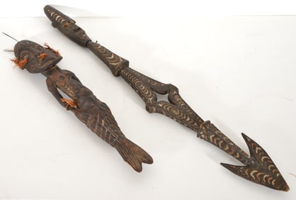2 carved and colored carved oceanic items, one a merman and the other a stylized spear with figural