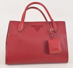 Prada red leather handbag with black piping. Marked on interior. With dust bag. 12.5in wide.