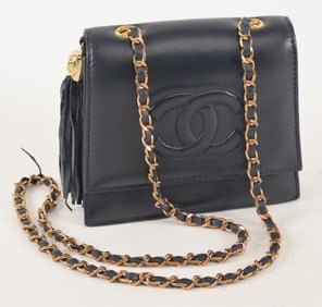 Small Chanel black leather purse with long chain.