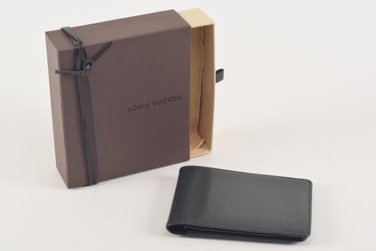 Louis Vuitton leather bifold wallet. Includes original box and dust bag. Wallet: 5in wide.