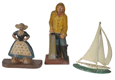 Lot of 3 antique cast iron doorstops. Old Salt, Dutch Girl, and Sailboat. 14in highest.