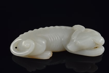 Jade carving. China. 17th century. Grey-green stone. Carving of a resting dog. 3.25in.