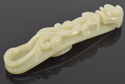 Large carved celadon jade garment hook. China. Early 20th century.