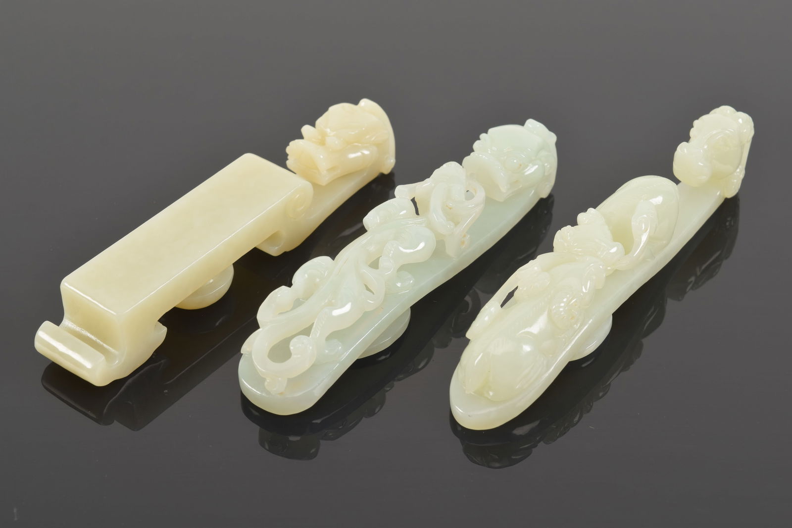 3 jade garment hooks. China. 19th century. Largest 4in.: 3 jade garment hooks. China. 19th century. Largest 4in.