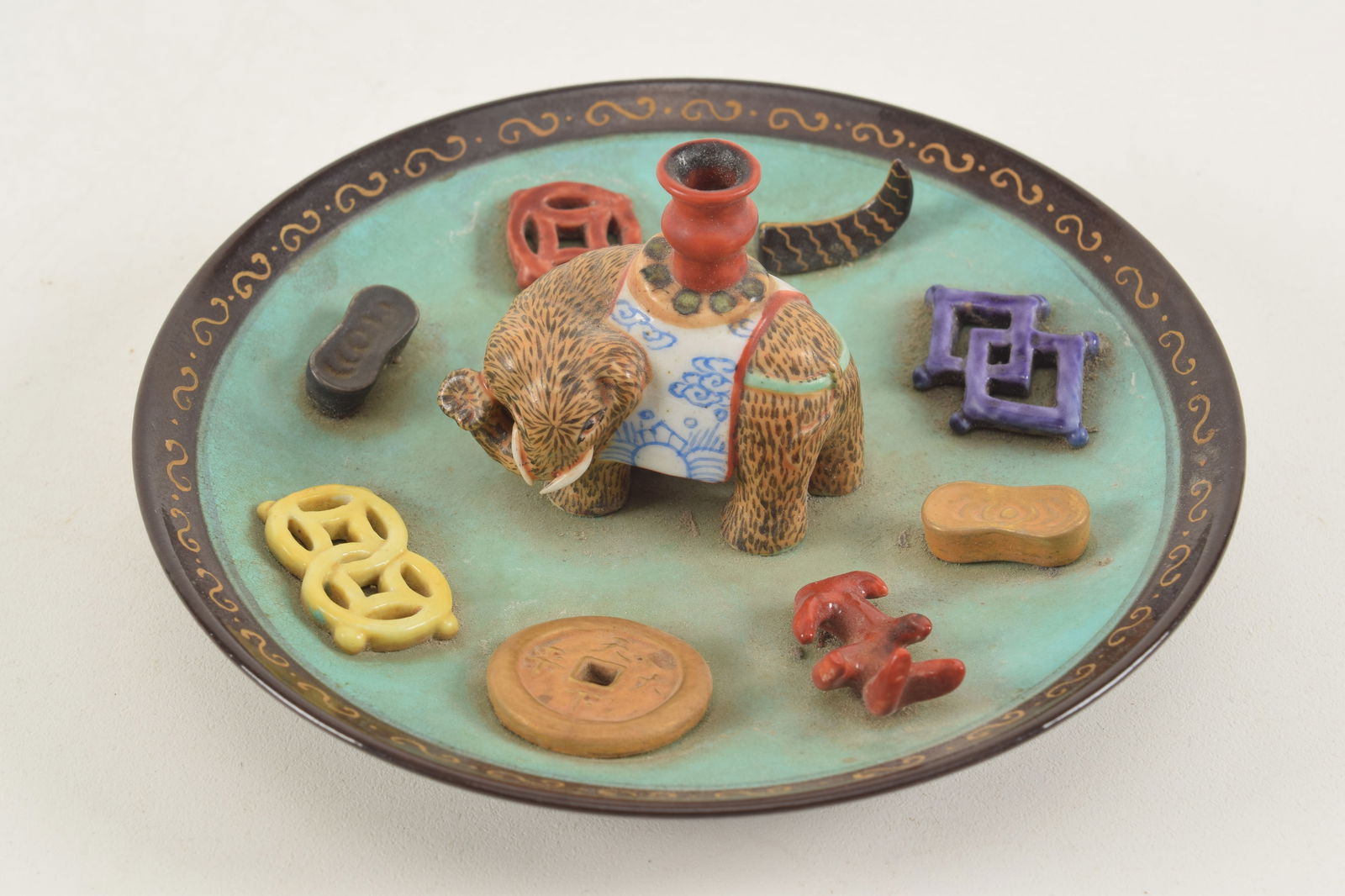Incense stick holder. China. 19th century. Saucer shaped with an elephant, valuable objects and (1 of 6)