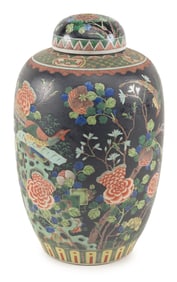 Porcelain covered jar. China. Early 20th century. Famille noir decoration of birds and flowers.