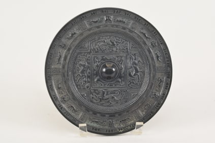 Bronze mirror. China. Han period (2nd century BC to 2nd century AD). Surface decorated with mythical