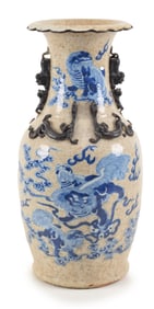 Porcelain vase. China. Late 19th century. Oatmeal ground with underglaze blue foo dogs, brocade
