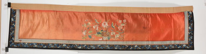 Embroidery of lotus flowers on a scarlet ground. China. 19th century. 74 x 19in.