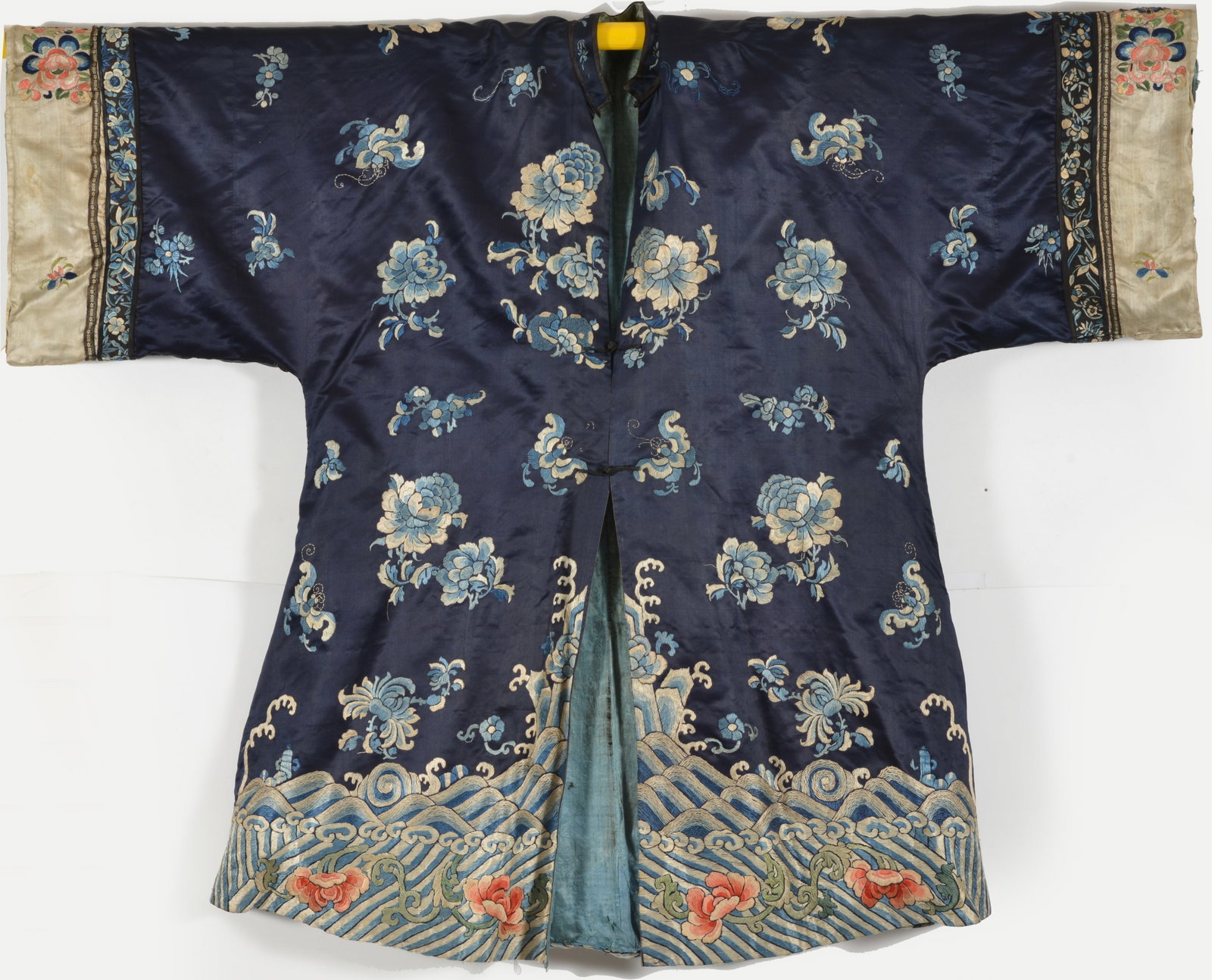 Women's informal robe. China. Early 20th century. Floral embroidery on a dark blue ground. Stains: Women's informal robe. China. Early 20th century. Floral embroidery on a dark blue ground. Stains and wear.