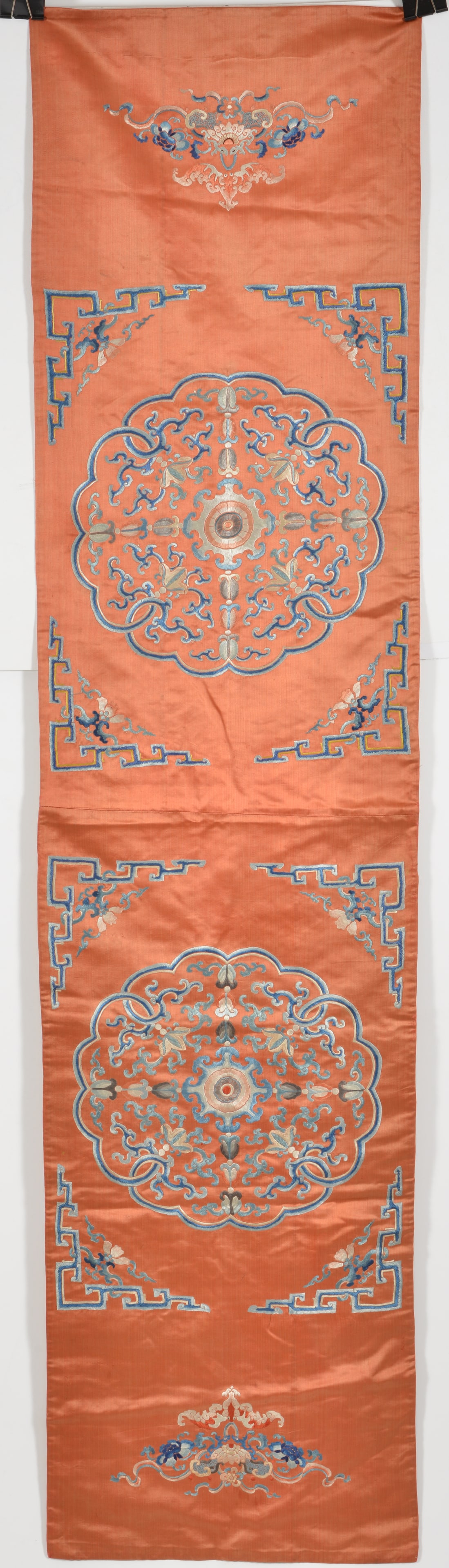 Embroidered chair cover. China. 19th century. Abstract floral designs on a scarlet orange ground. (1 of 4)