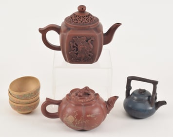 Lot of 6 Yi Hsing pieces. To include: 3 teapots and 3 small cups. Smallest teapot blue paint