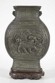 Large bronze vase. China. 18th century. surface decorated in high relief with buddhistic lions.