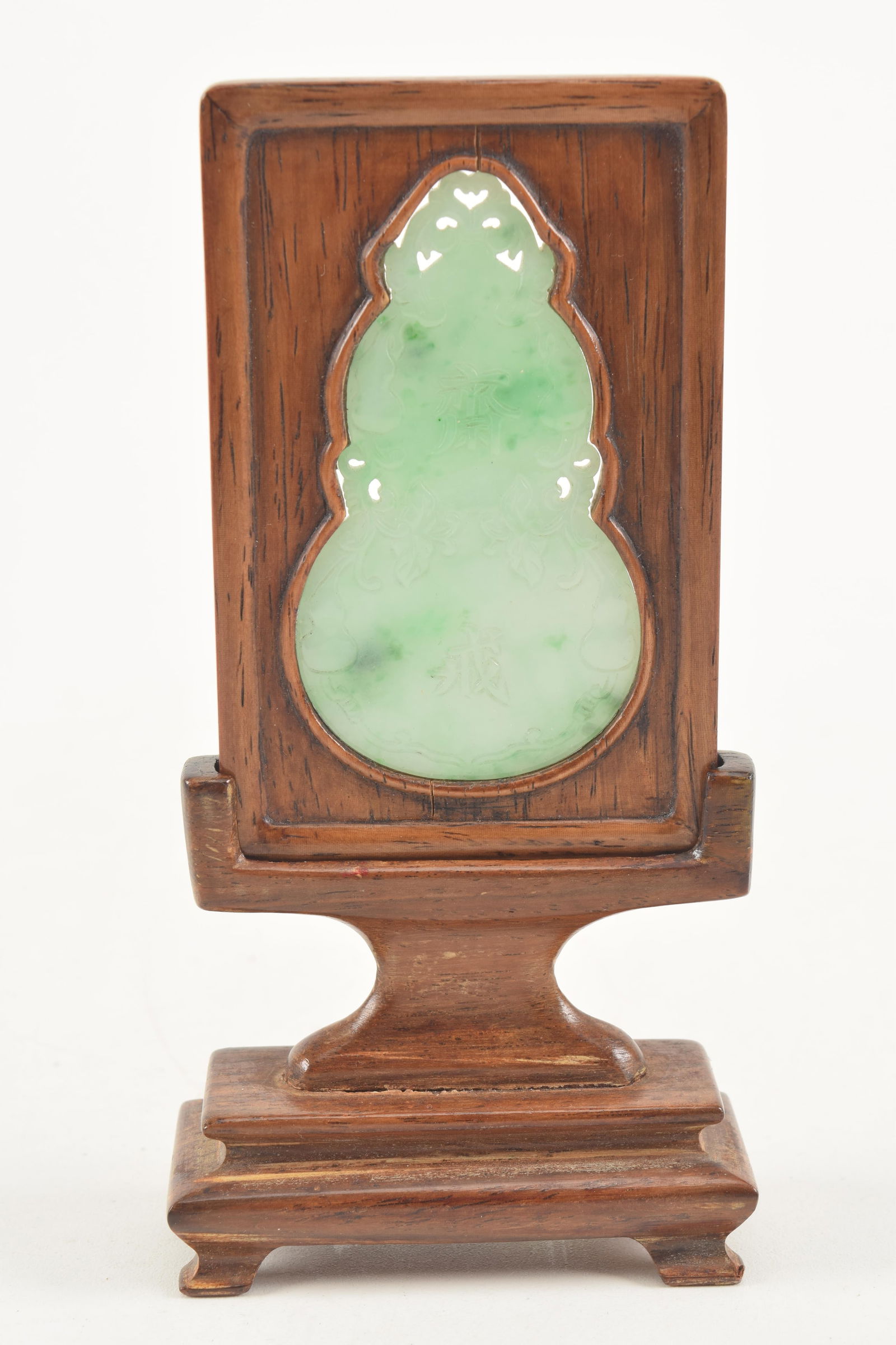 Jade abstinence plaque. China. 19th century. Apple green jadeite carved as a double gourd with a (1 of 4)
