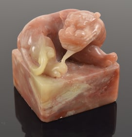 Soapstone seal. China. 20th century. Foo dog finial. Grey and pink stone. 1.75in high.