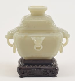 Jade censer. China. 18th/19th century. Celadon colored stone. Squared form. Tao tieh masks and lion