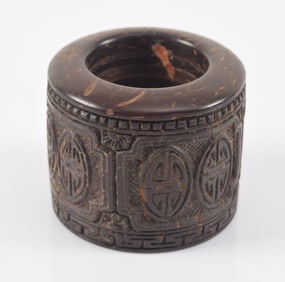 Coconut archers ring. China. 19th century. Carved surface.