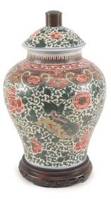 Porcelain covered jar. China. 17th century. Wu Tsai ware with a foo dog and peony design. Drilled
