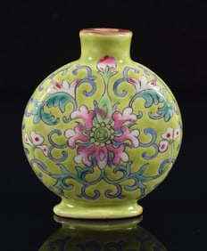 Porcelain snuff bottle. China. 19th century. Chia Ching mark. Stylized floral scrolling on a lime