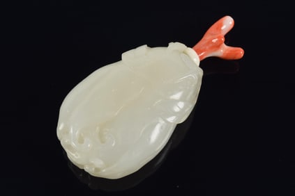 Pure white jade snuff bottle. China. 18th century. Carved as a buddhas hand citron. Coral stopper.