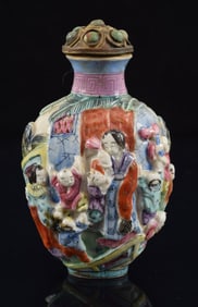 Porcelain snuff bottle. China. 19th century. Molded decoration of children playing. 3in.