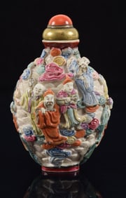Porcelain snuff bottle. China. 19th century. Molded decoration of Taoist divinities. 3in.