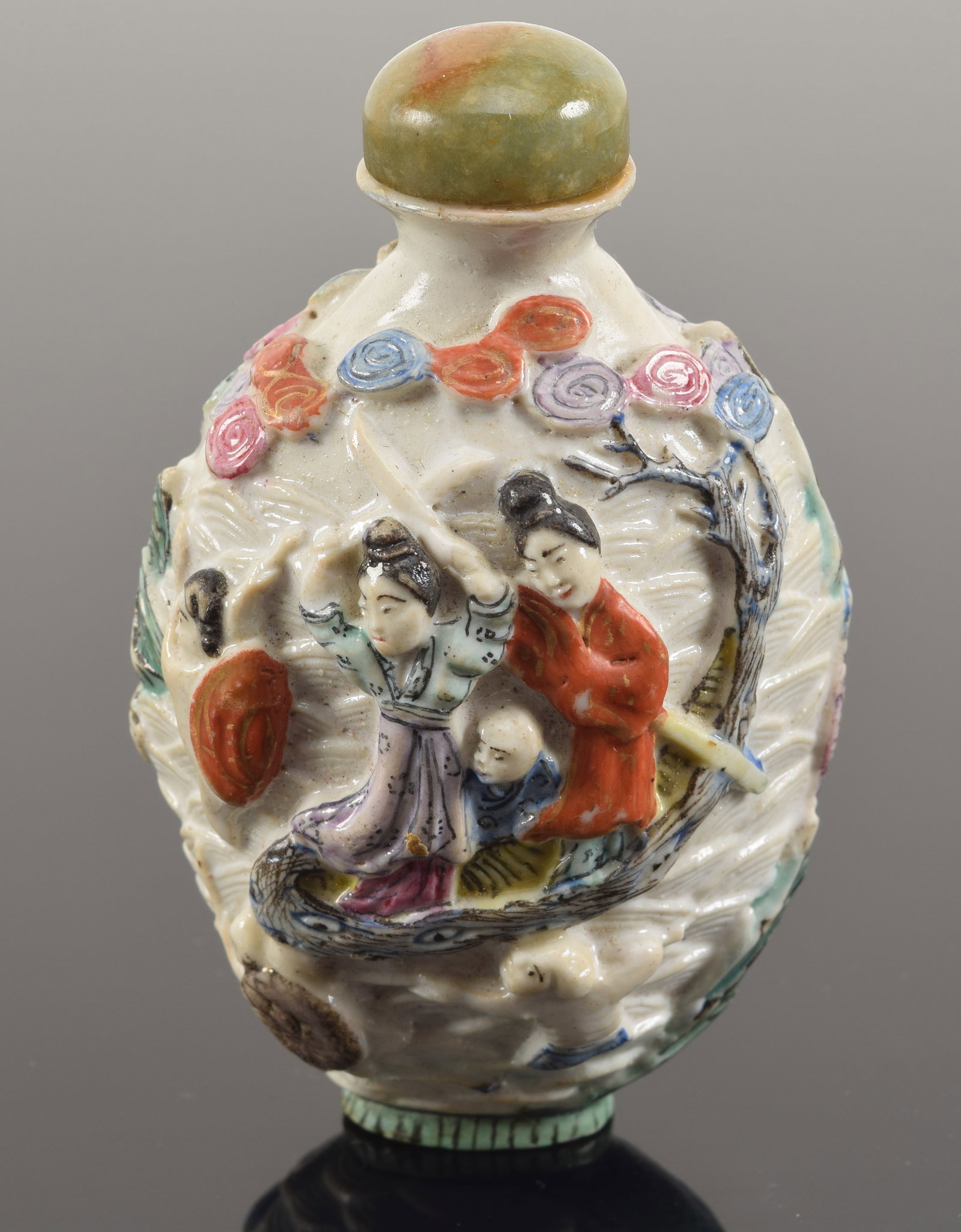 Porcelain snuff bottle. China. 19th century. Molded decoration of buddhist divinities. 3in.: Porcelain snuff bottle. China. 19th century. Molded decoration of buddhist divinities. 3in.