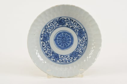 Porcelain bowl. China. Ming period, ca. 1570. Molded chrysanthemum shape with underglaze blue floral