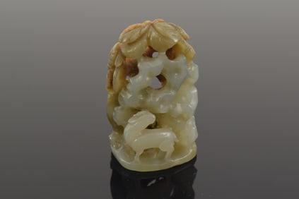 Jade hat finial. China. Yuan to early Ming. Grey stone with a russet area. Carving of a tiger, deer