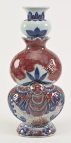 Porcelain vase. China. 18th century. Molded form of three sections: base with a butterfly, mid