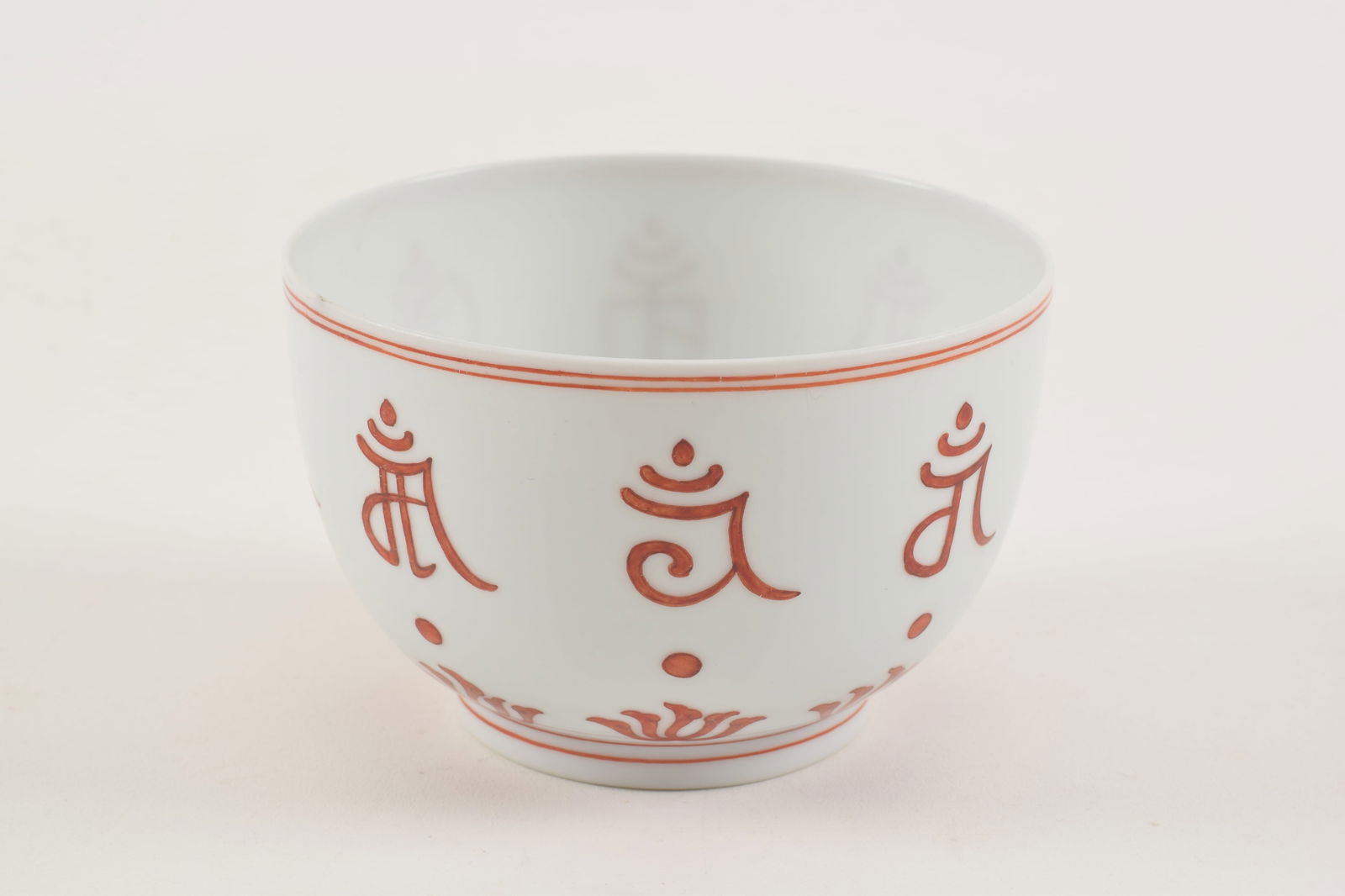 Porcelain cup. China. Kang Hsi mark (1662-1722) and of the period. Iron red decoration of Sanskrit (1 of 7)