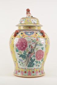 Porcelain covered jar. China. 19th century. Baluster form with animal form lugs and finial. Yellow