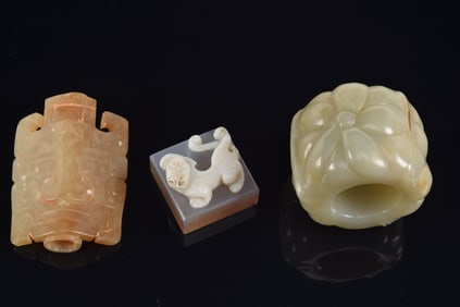 3 jades. to include: a Han period Tao Tieh mask, an agate seal and a floral ring. Largest 2.5in.