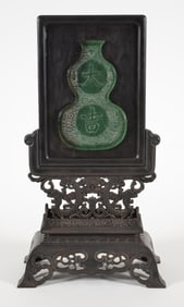 Table screen. China. 20th century. Green stone plaque carved as a double gourd with the characters