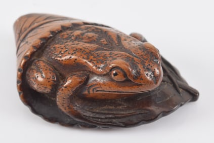 Carved toggle. Japan. 18th century. Netsuke of a frog on a leaf. Signed. 2in.
