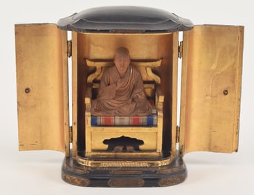 Traveling shrine. Japan. 19th century. Carved and gilt wood figure of a high abbot. Gilt metal