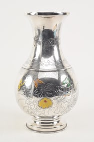 Silver vase. Japan. Meiji period (1868-1912). Surface engraved with flowers and various borders.