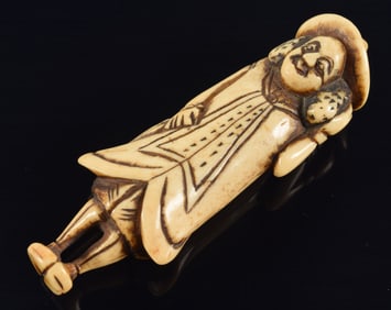 Carved toggle. Japan. 18th century. Netsuke figure of a foreigner. 3in length.