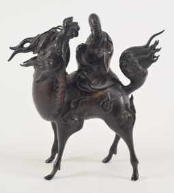 Bronze censer. Japan. 19th century. Shao Lao on the back of a kylin. 8 x 8.75in.