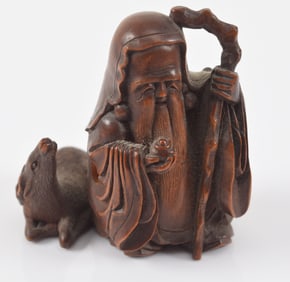 Carved toggle. Japan. 19th century. Netsuke of Jurojin and a stag. 2 x 2in. signed Tadanao.