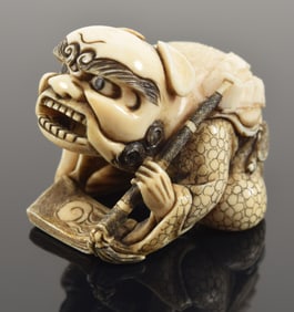 Carved netsuke of shishi mask dancer. Japan. 19th century. 1.75in signed.