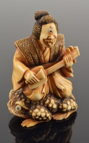 Carved netsuke. Japan. 19th century. Cyclops playing a samisen on the back of a frog. Signed. 2in.